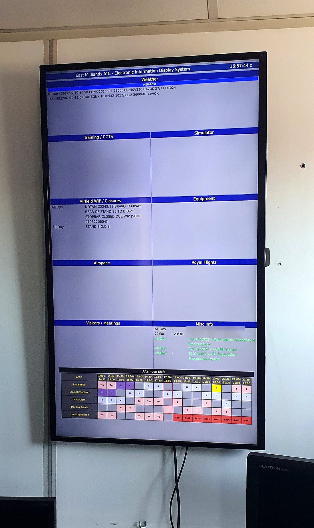 A wall-mounted MEIDS briefing board displaying airfield works, training, equipment and visitor information